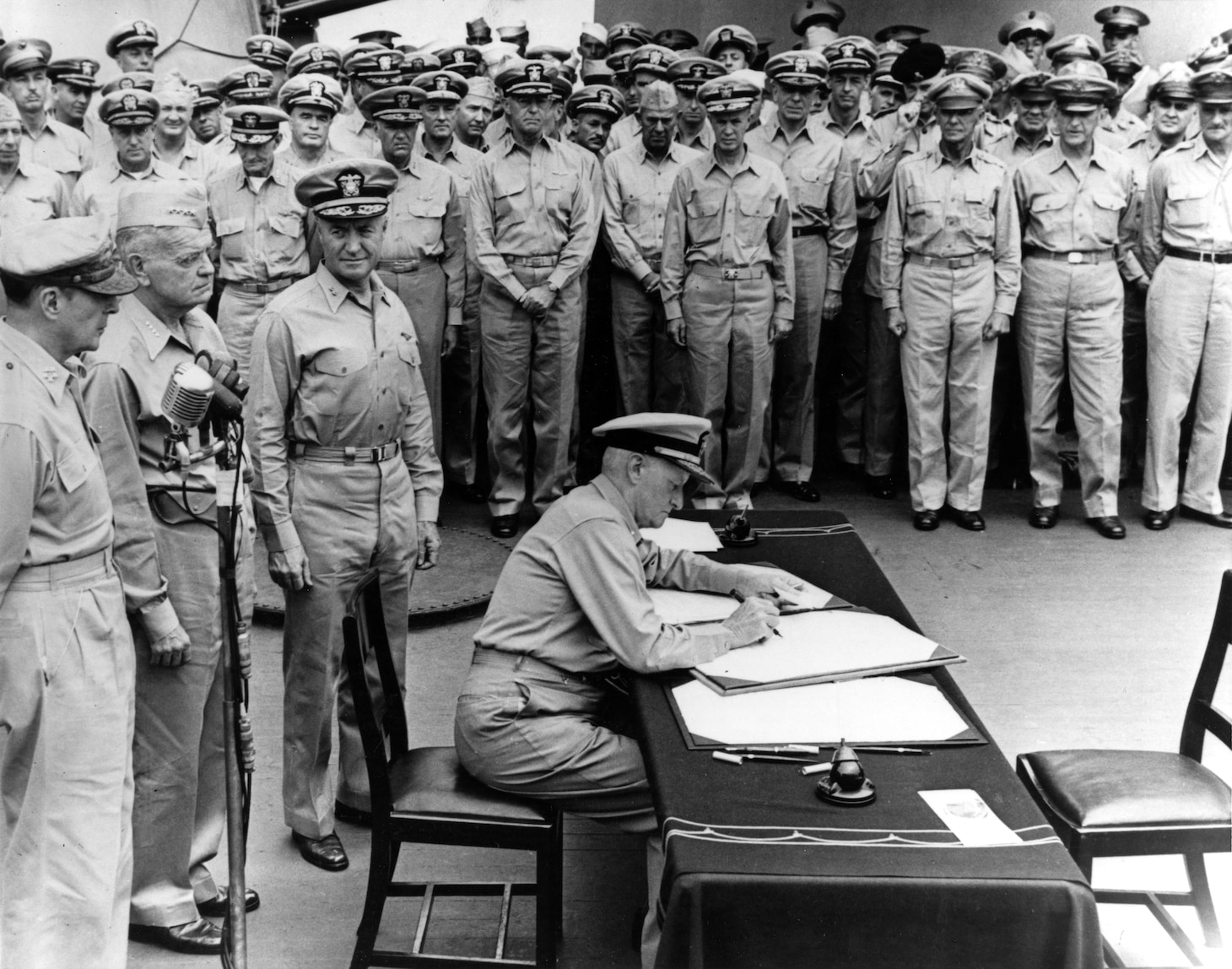 Fleet Admiral Chester W. Nimitz signs the Instrument of Surrender as United States Representative aboard the battleship USS Missouri (BB-63) in Tokyo, Japan,  Sept. 2, 1945.