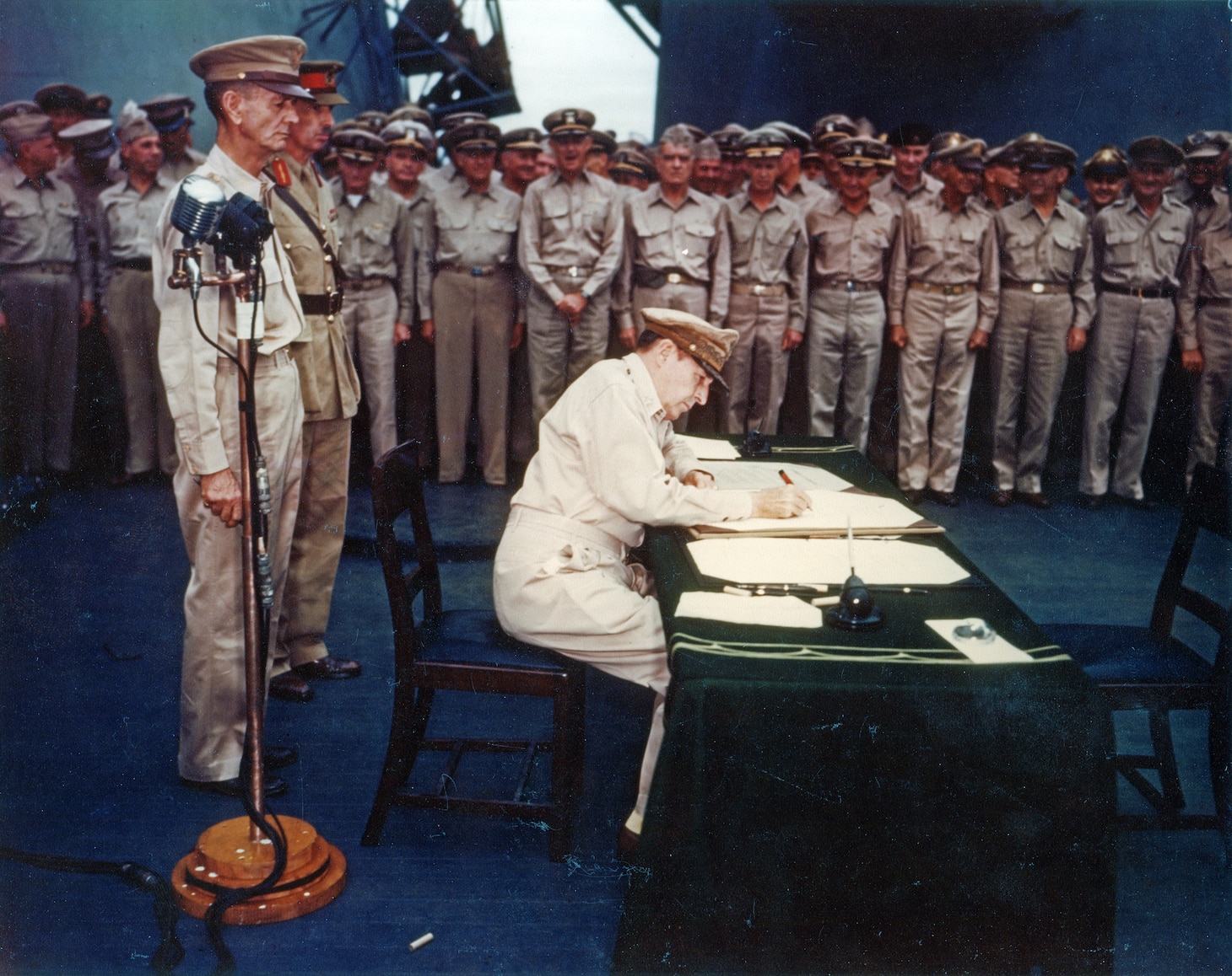 General of the Army Douglas MacArthur signs the signs the Instrument of Surrender as Supreme Allied Commander aboard the battleship USS Missouri (BB-63) in Tokyo, Japan, Sept. 2, 1945.