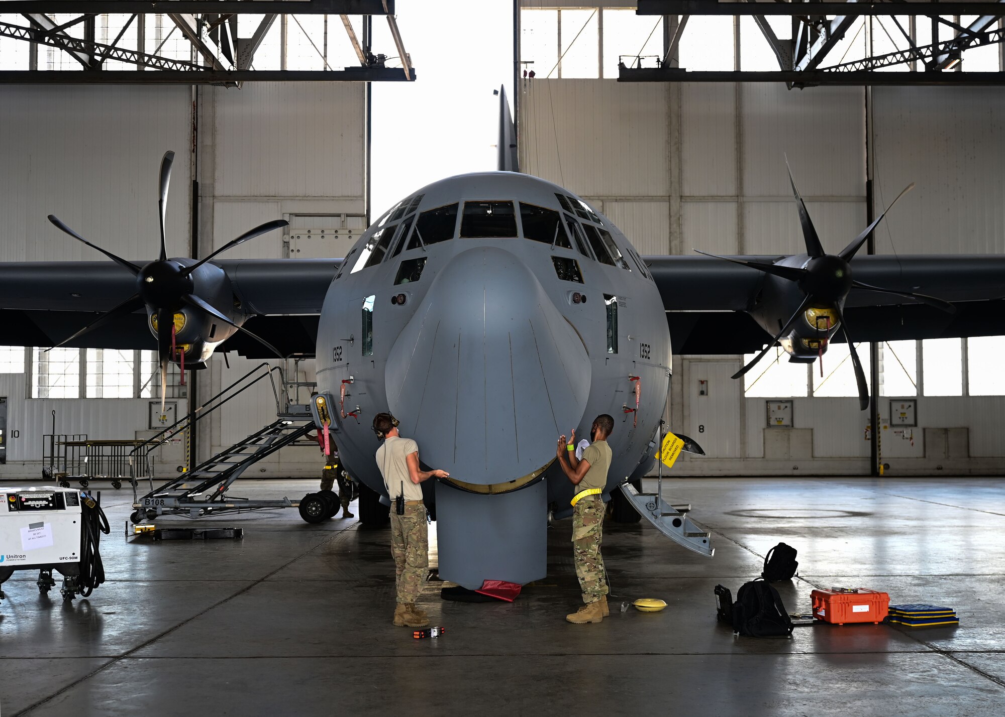 Airmen perform maintenance on an aircraft