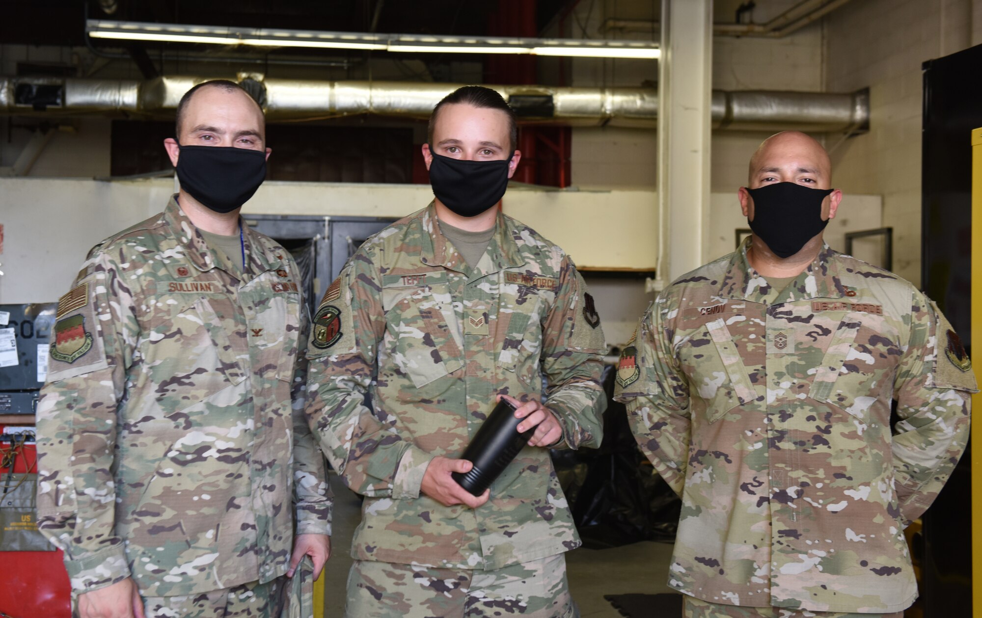 Image of an Airman accepting a Weasel of the Week award.