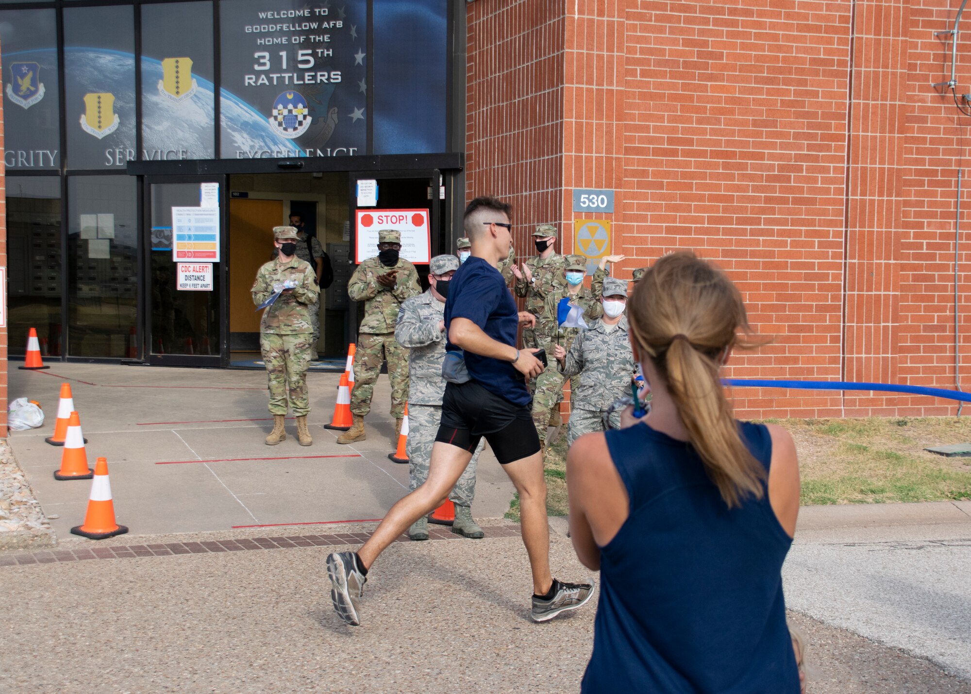U.S. Air Force 1st Lt. Christian Bills, 315th Training Squadron student, races through the 2020 Air Force Marathon finish-line, virtually hosted outside of the 315th TRS schoolhouse, on Goodfellow Air Force Base, Texas, Sept. 1, 2020. The AFM operated virtually for the health and safety of participants and others involved, while the COVID-19 pandemic existed. (Courtesy photo by Mr. Tony Lynch)