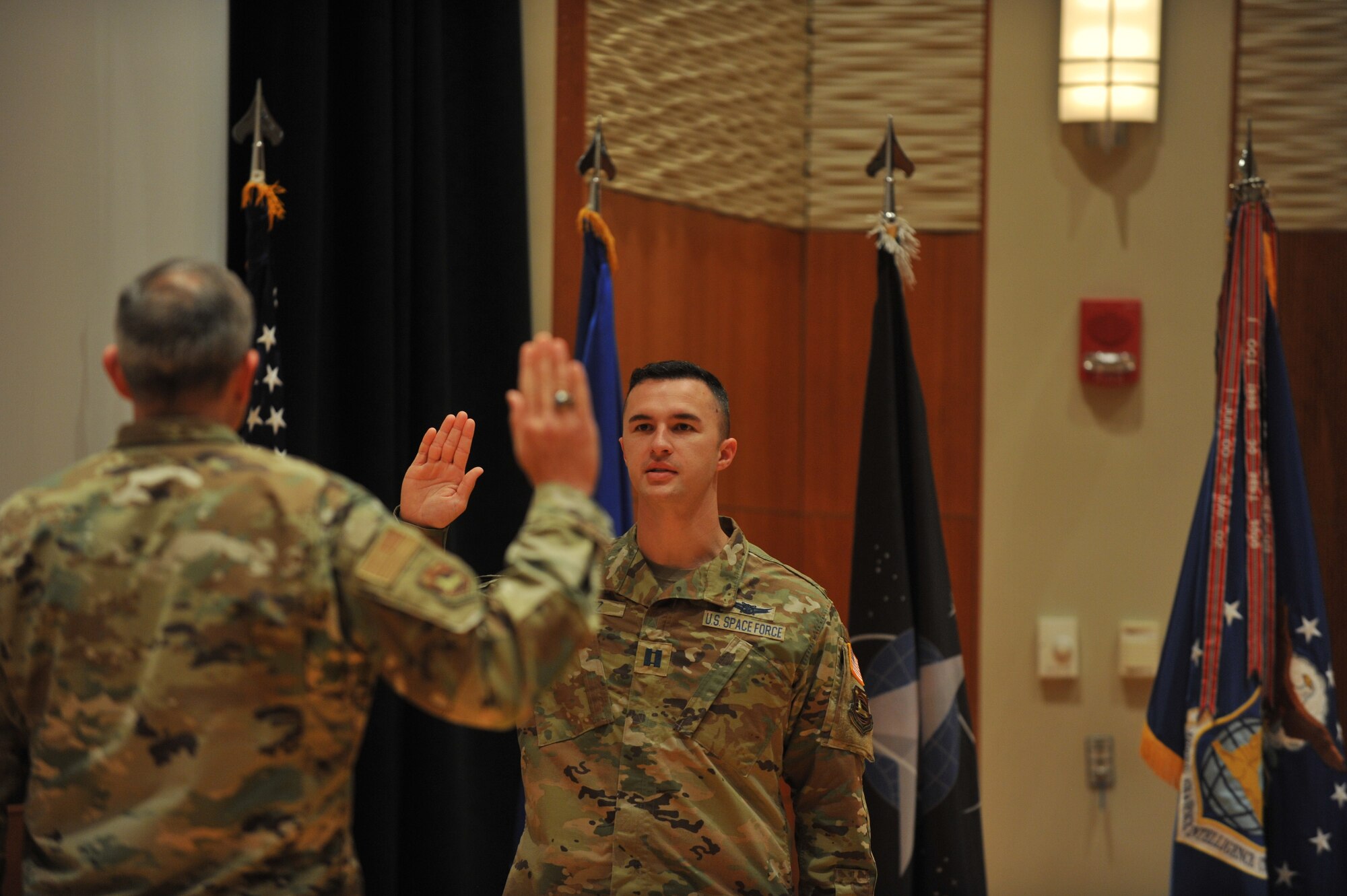 Eight of NASIC’s space operators recite the oath of enlistment during a transfer ceremony here Sept. 1. Administered by NASIC commander Col. Maurizio Calabrese, the oath is a military tradition that provides an opportunity for the members to reaffirm their commitment to the armed services. (U.S. Air Force photo by Senior Airmen Samuel Earick)