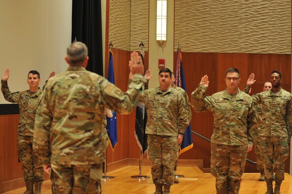 Eight of NASIC’s space operators recite the oath of enlistment during a transfer ceremony here Sept. 1. Administered by NASIC commander Col. Maurizio Calabrese, the oath is a military tradition that provides an opportunity for the members to reaffirm their commitment to the armed services. (U.S. Air Force photo by Senior Airmen Samuel Earick)