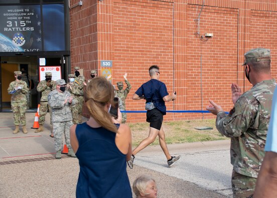 U.S. Air Force 1st Lt. Christian Bills, 315th Training Squadron student, races through the 2020 Air Force Marathon finish-line, virtually hosted outside of the 315th TRS schoolhouse, on Goodfellow Air Force Base, Texas, Sept. 1, 2020. The AFM operated virtually for the health and safety of participants and others involved, while the COVID-19 pandemic existed. (Courtesy photo by Mr. Tony Lynch)