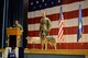 Tedy, a German shepherd, stands next to his handler during the Military Working Dog's retirement ceremony.