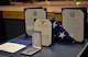 Certificates, a U.S. flag, and a meritorious service medal presented to Military Working Dog Tedy in honor of his retirement sit on a table.
