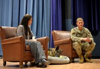 The family who adopted military working dog Tedy, a German shepherd, do a media interview after Tedy's retirement ceremony.