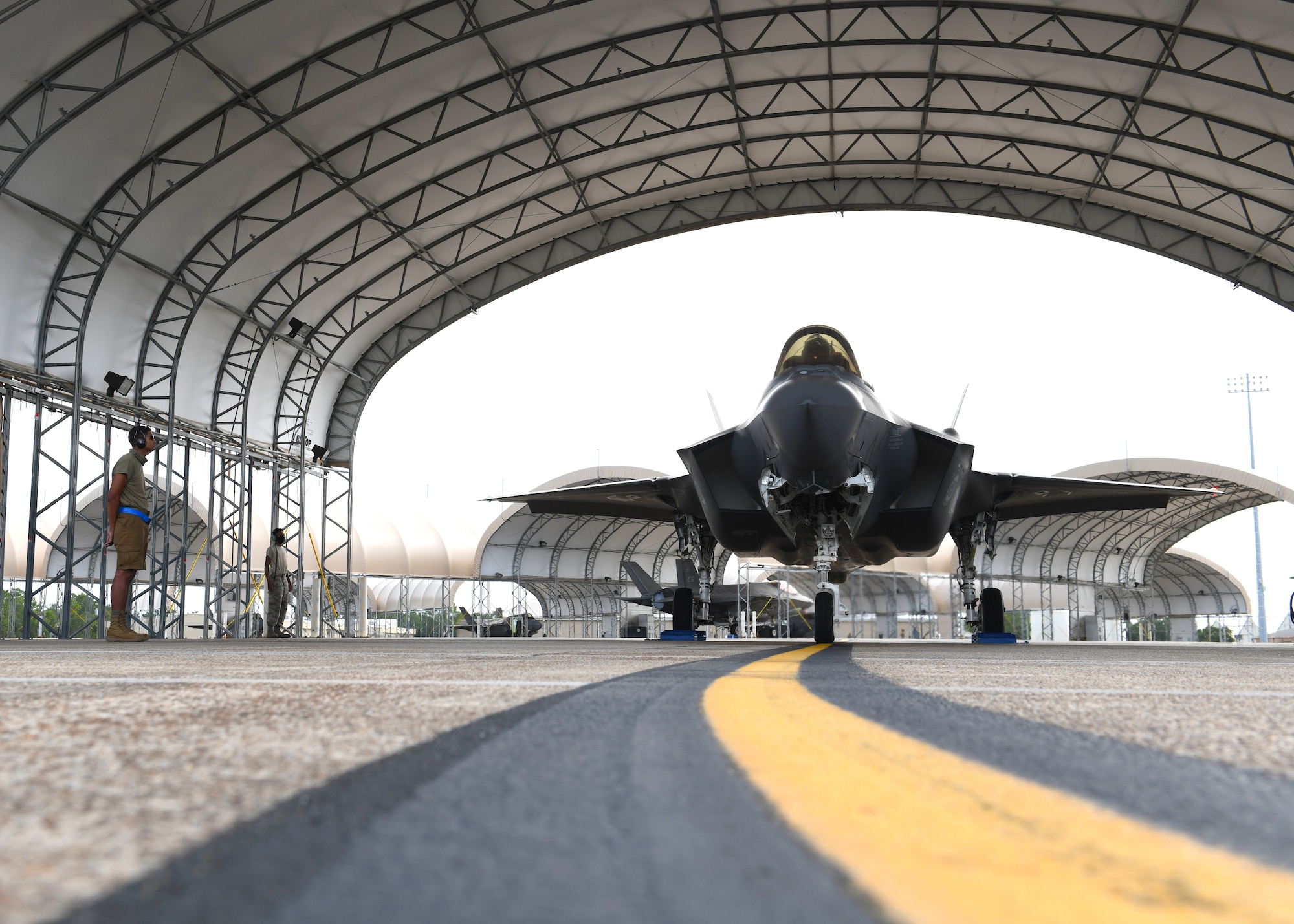 U.S. Air Force Airman 1st Class Jaivon Bland, 33rd Aircraft Maintenance squadron F-35A Lightning II dedicated crew chief, conducts launch procedures at Eglin Air Force Base, Florida, Aug. 26, 2020. The 33rd AMXS introduced a shorts uniform to help combat hot weather conditions on the flightline. (U.S. Air Force photo by Airman 1st Class Amber Litteral)