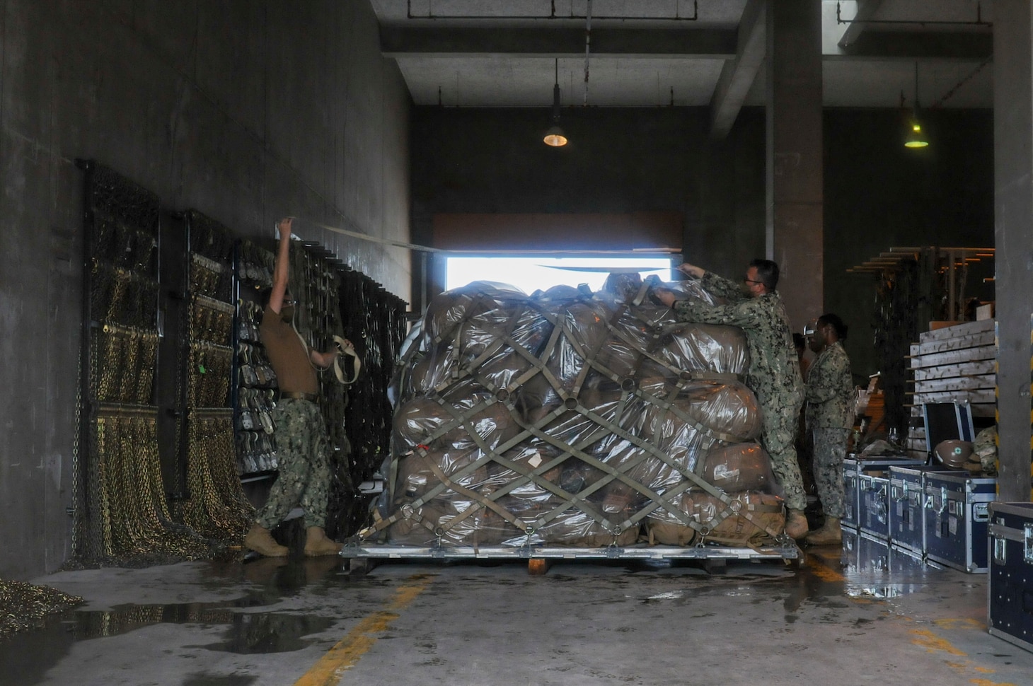 200825-N-TP832-1011 OKINAWA, Japan (Aug. 25, 2020) Seabees assigned to U.S. Naval Mobile Construction Battalion (NMCB) 3 use straps to secure personnel gear issue on a 463L pallet during a 48-hour mount out exercise on board Camp Shields in Okinawa, Japan. NMCB-3 is deployed across the Indo-Pacific region conducting high-quality construction to support U.S. and partner nations to strengthen partnerships, deter aggression, and enable expeditionary logistics and naval power projection. The battalion stands ready to complete assigned tasking, support Humanitarian Aid/Disaster Relief and Major Combat Operations throughout the area of responsibility. (U.S. Navy photo by Mass Communication Specialist 2nd Class Michael Lopez/Released)