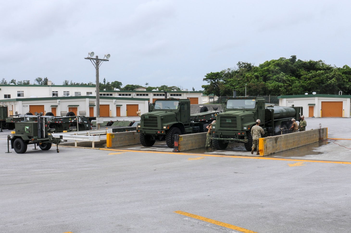 200825-N-TP832-1207 OKINAWA, Japan (Aug. 25, 2020) Seabees assigned to U.S. Naval Mobile Construction Battalion (NMCB) 3 wash an MK31 and MK28C medium tactical vehicle replacement truck during a 48-hour mount out exercise on board Camp Shields in Okinawa, Japan. NMCB-3 is deployed across the Indo-Pacific region conducting high-quality construction to support U.S. and partner nations to strengthen partnerships, deter aggression, and enable expeditionary logistics and naval power projection. The battalion stands ready to complete assigned tasking, support Humanitarian Aid/Disaster Relief and Major Combat Operations throughout the area of responsibility. (U.S. Navy photo by Mass Communication Specialist 2nd Class Michael Lopez/Released)