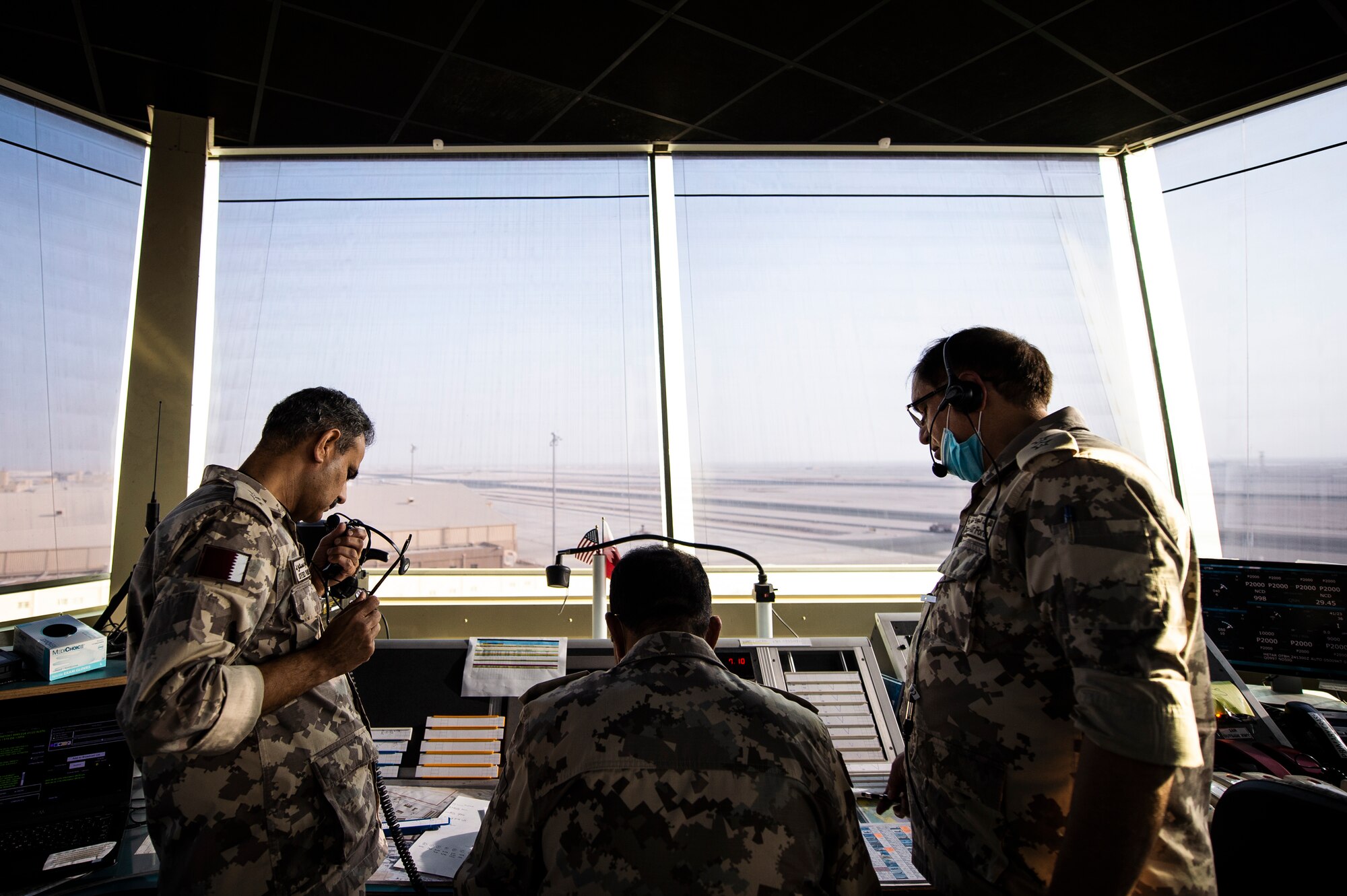 Members of the Qatar Emiri Air Force (QEAF) air traffic control tower work together to direct aircraft at Al Udeid Air Base, Qatar, Aug. 24, 2020. A letter of agreement was recently implemented between the U.S., QEAF and Qatar Civil Aviation Authority to better work together to ensure safe air space operations. (U.S. Air Force photo by Master Sgt. Larry E. Reid Jr.)