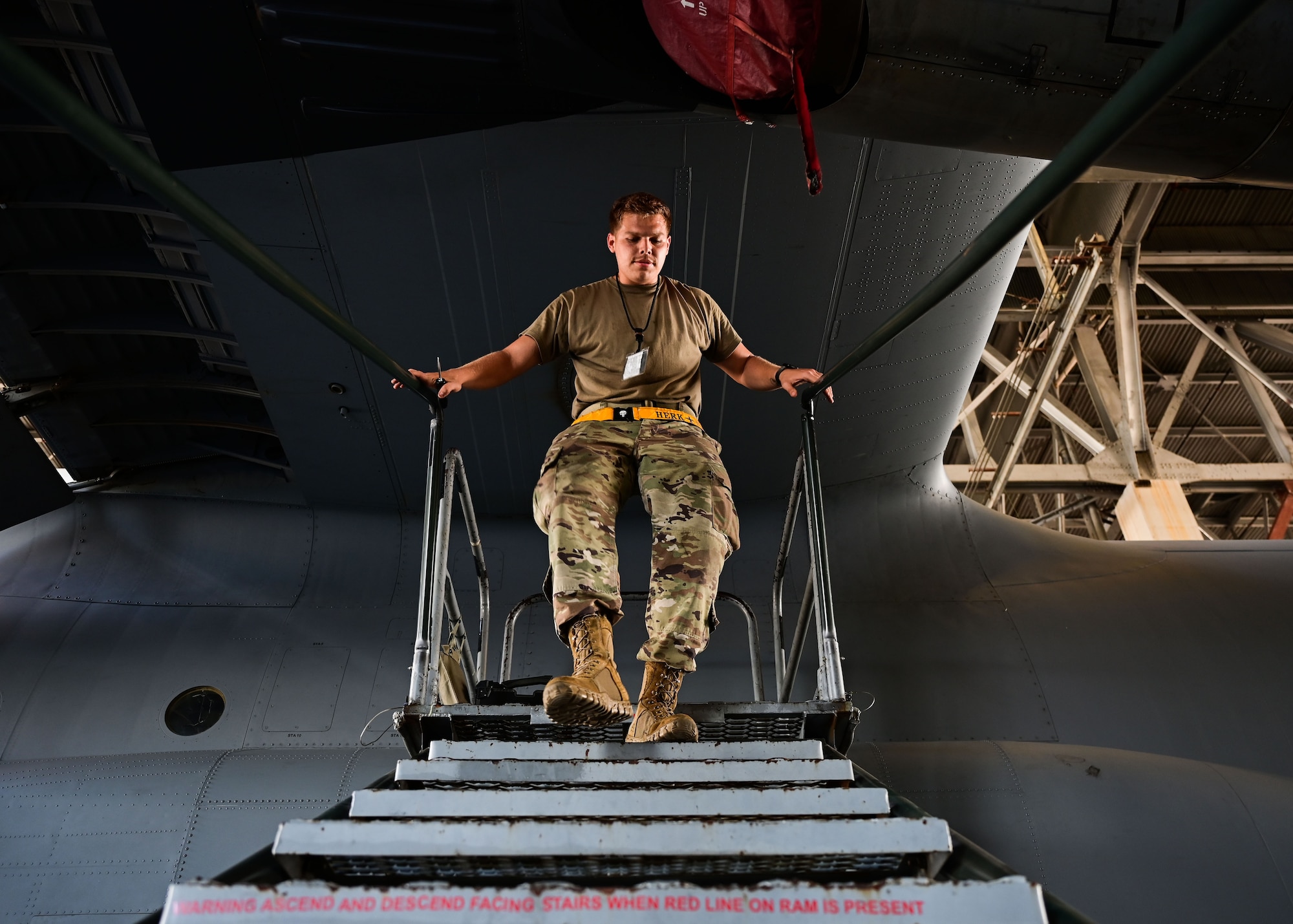 An Airman walks down a set of stairs