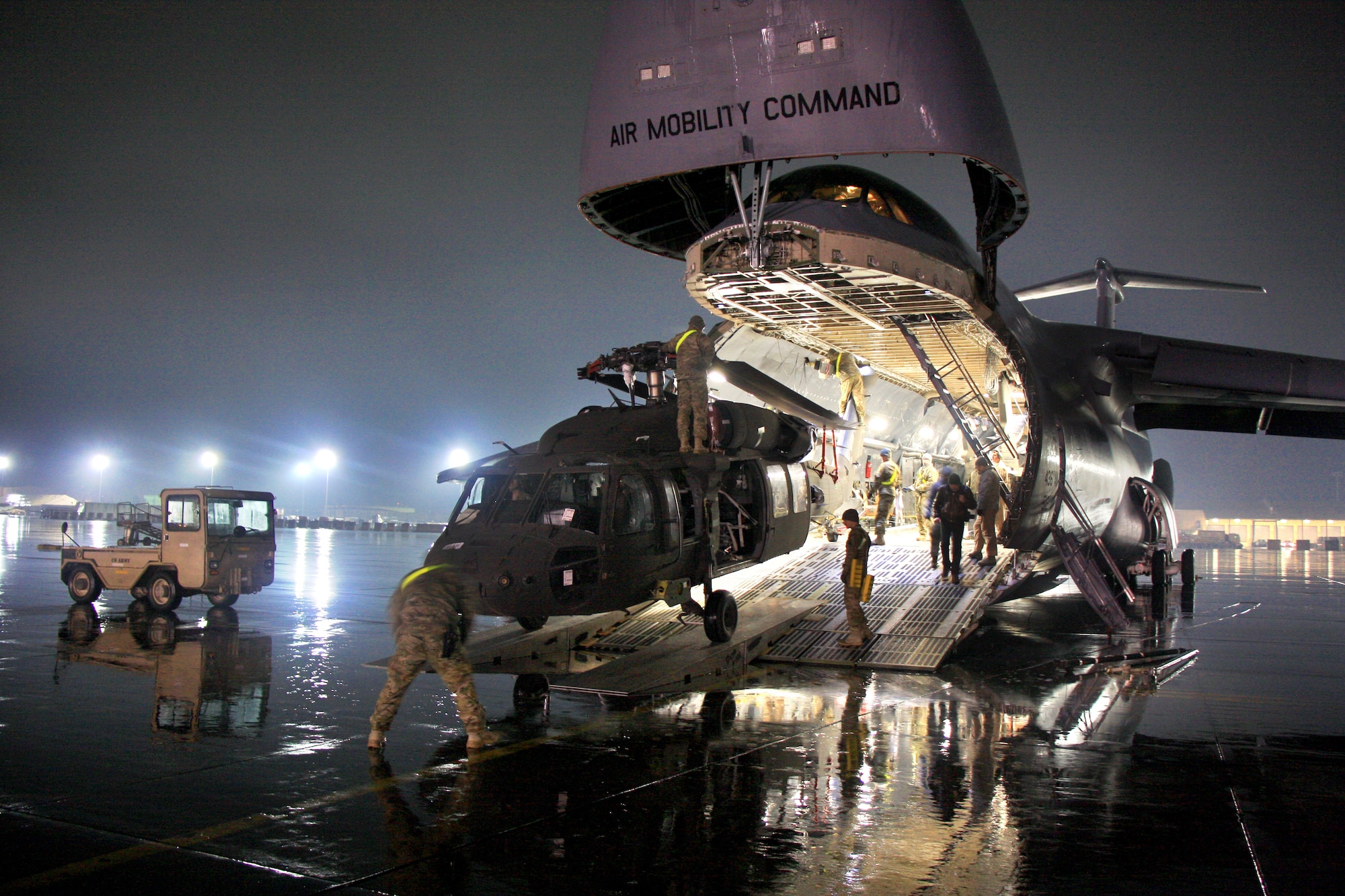 U.S. Service members unload a U.S. Army UH-60 Black Hawk helicopter from a U.S. Air Force C-5 Galaxy transport aircraft at Bagram Airfield, in Parwan province, Afghanistan, Feb. 2, 2013.  (U.S. Army photo by 1st Lt. Henry Chan/Released)