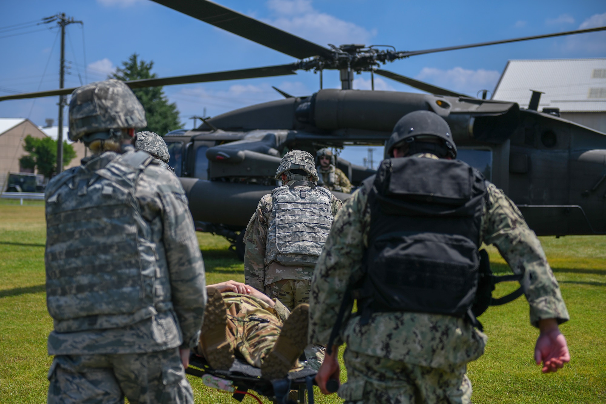 Soldiers, Sailors and Airmen participate in gurney carry as part of Tactical Combat Casualty Care.