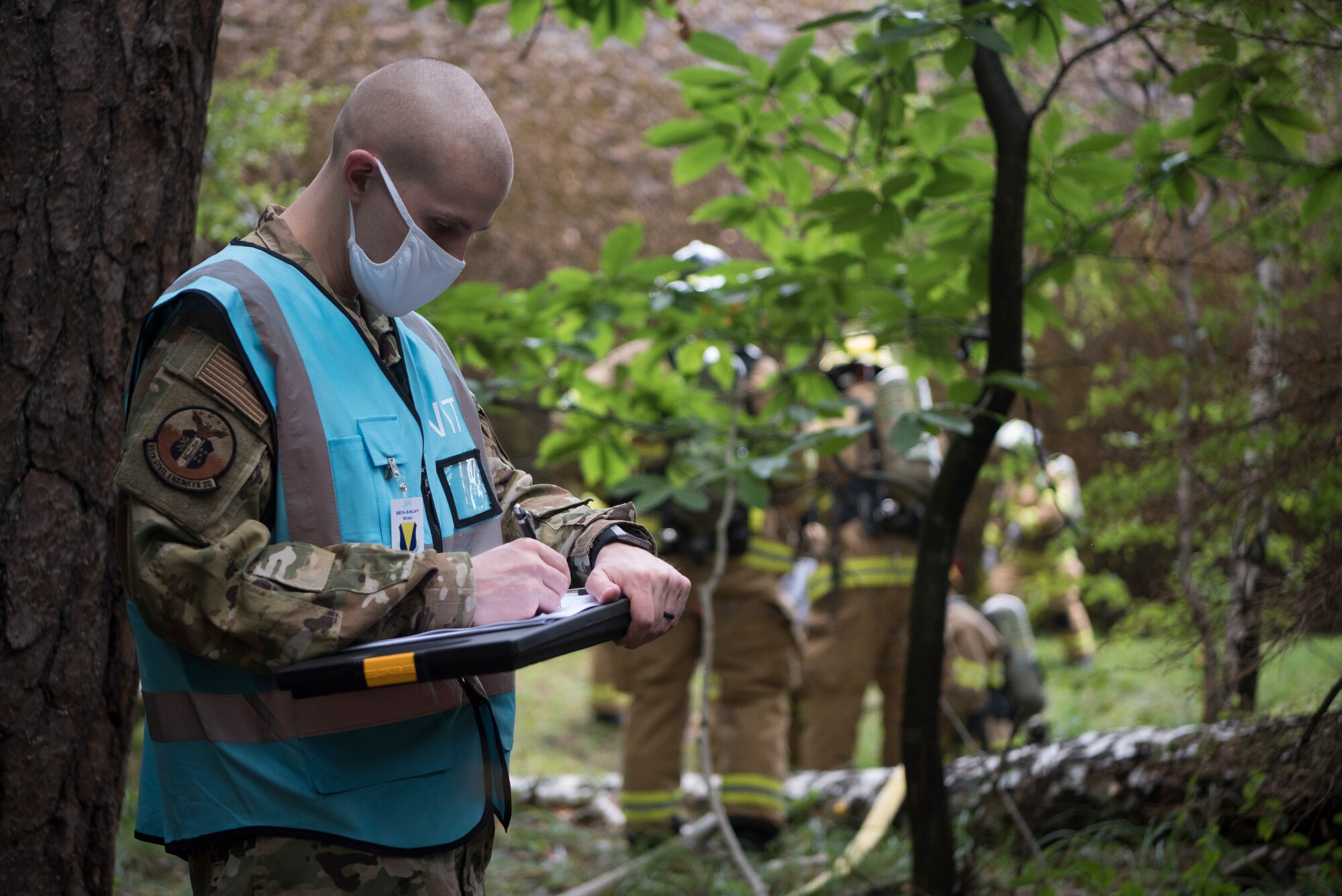 Airman writes down observations.