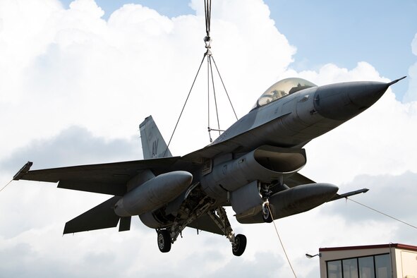 An F-16 Fighting Falcon is lifted by a crane at Aviano Air Base, Italy, Aug. 29, 2020. Airmen from the 31st Maintenance Squadron and 52nd MXS used the aircraft in a Crashed Damaged Disabled Aircraft Recovery training event. (U.S. Air Force photo by Senior Airman Caleb House)