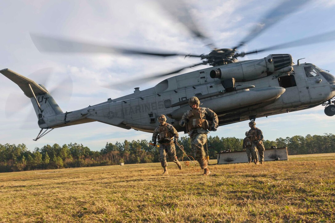 U.S. Marine landing support specialist with Combat Logistics Battalion 22, 22nd Marine Expeditionary Unit, run after connecting a beam to a CH-53E Super Stallion during a helicopter support team training exercise at the Condor Range aboard Camp Lejeune, N.C., January 22, 2020. Marines and Sailors with the 22nd MEU are currently conducting pre-deployment training in preparation for their mission as Special Purpose Marine Air-Ground Task Force 20.2. (U.S. Marine Corps photo by Cpl. Tawanya Norwood)