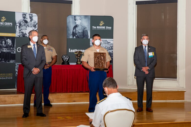 U.S. Marine Corps Cpl. Joseph Rasdal, center, Wounded Warrior Battalion-West, receives the Navy and Marine Corps Achievement Medal and the Recovering Service Member of the Year award during the 10th annual Wounded Warrior Leadership Awards ceremony hosted by the Marine Corps Association and Foundation (MCA&F), at the Marston Pavilion on Marine Corps Base Camp Lejeune, North Carolina, Aug. 20, 2020. Six Marines and civilians with the Wounded Warrior Regiment were recognized by MCA&F for their professionalism, exceptional leadership and achievements. (U.S. Marine Corps photo by Lance Cpl. Christian Ayers)