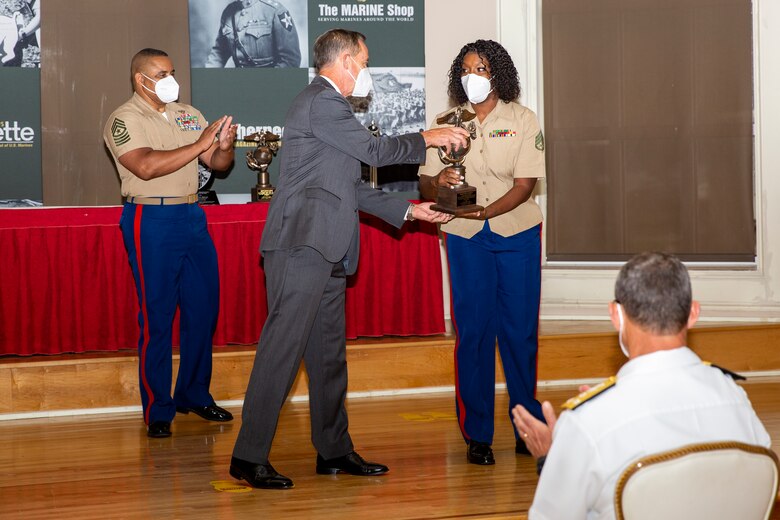 William Faulkner, center, President and CEO of Marine Corps Association and Foundation (MCA&F), presents the Section Leader of the Year award to U.S. Marine Corps Staff Sgt. Marquita Davis, right, a section leader with Wounded Warrior Battalion-East, during the 10th annual Wounded Warrior Leadership Awards ceremony hosted by the MCA&F, at the Marston Pavilion on Marine Corps Base Camp Lejeune, North Carolina, Aug. 20, 2020. Six Marines and civilians with the Wounded Warrior Regiment were recognized by MCA&F for their professionalism, exceptional leadership and achievements.  (U.S. Marine Corps photo by Lance Cpl. Christian Ayers)