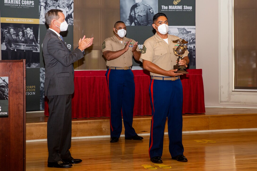 U.S. Marine Corps Staff Sgt. Jose Acosta-Garcia, right, a section leader with Alpha Company, Wounded Warrior Battalion-East, receives the Enlisted Leader of the Year award during the 10th annual Wounded Warrior Leadership Awards ceremony held by the Marine Corps Association and Foundation, (MCA&F), at the Marston Pavilion on Marine Corps Base Camp Lejeune, North Carolina, Aug. 20, 2020. Six Marines and civilians with the Wounded Warrior Regiment were recognized by MCA&F for their professionalism, exceptional leadership and achievements. (U.S. Marine Corps photo by Lance Cpl. Christian Ayers)