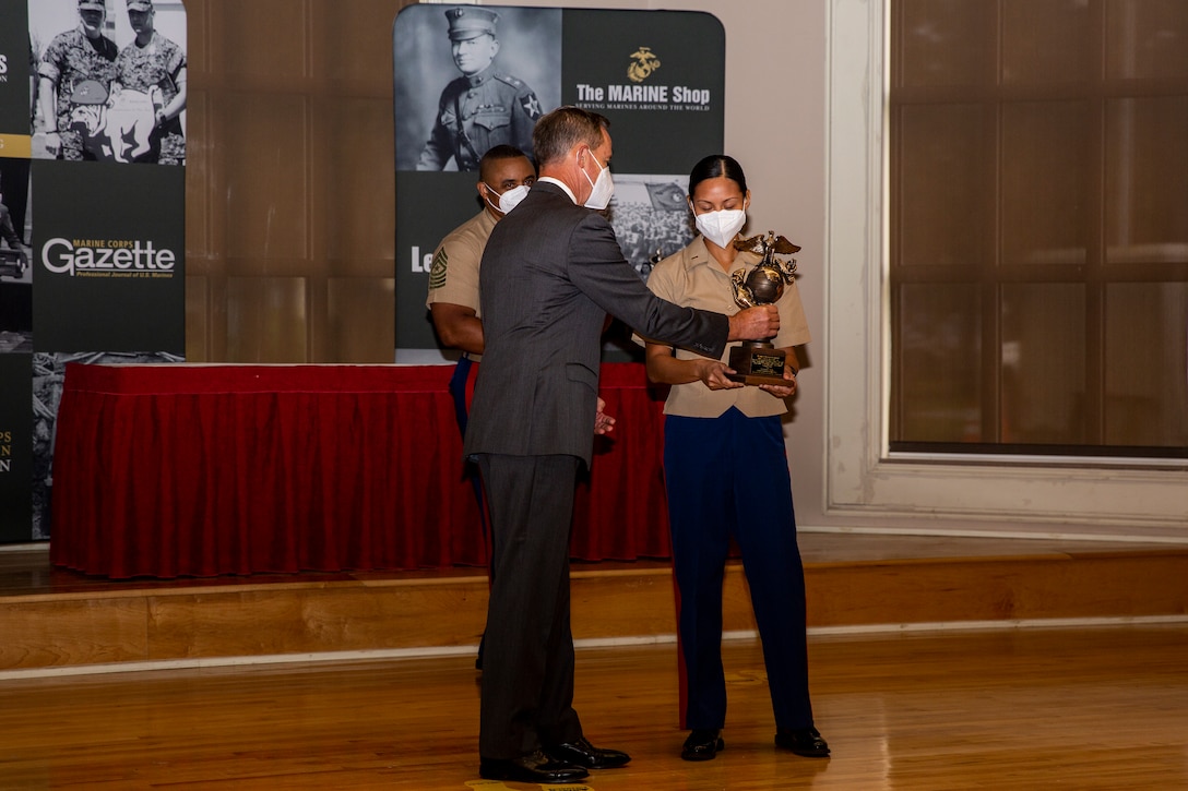 William Faulkner, left, President and CEO of Marine Corps Association and Foundation, (MCA&F), presents U.S. Marine Corps 1st Lt. Karen Martin, executive officer of Alpha Company, Wounded Warrior Battalion-East, the Officer Leader of the Year award during the 10th annual Wounded Warrior Leadership Awards ceremony held by the Marine Corps Association and Foundation, (MCA&F), at the Marston Pavilion on Marine Corps Base Camp Lejeune, North Carolina, Aug. 20, 2020. Six Marines and civilians with the Wounded Warrior Regiment were recognized by MCA&F for their professionalism, exceptional leadership and achievements. (U.S. Marine Corps photo by Lance Cpl. Christian Ayers)