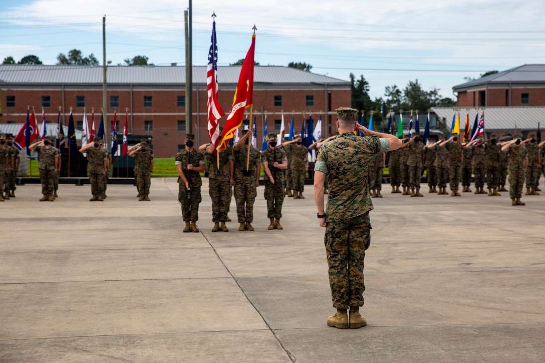 U.S. Marine Corps Capt. Nathaniel Simms, the company commander of Fox Company, 4th Tank Battalion, 4th Marine Division, salutes the colors during the company’s deactivation ceremony on Marine Corps Base Camp Lejeune at Stone Bay, North Carolina, Aug. 25, 2020. Gen. David H. Berger, the commandant of the Marine Corps, released Marine Corps Force Design 2030 in March 2020, which designates tanks as a large area of divestment. (U.S. Marine Corps photo by Lance Cpl. Christian Ayers)