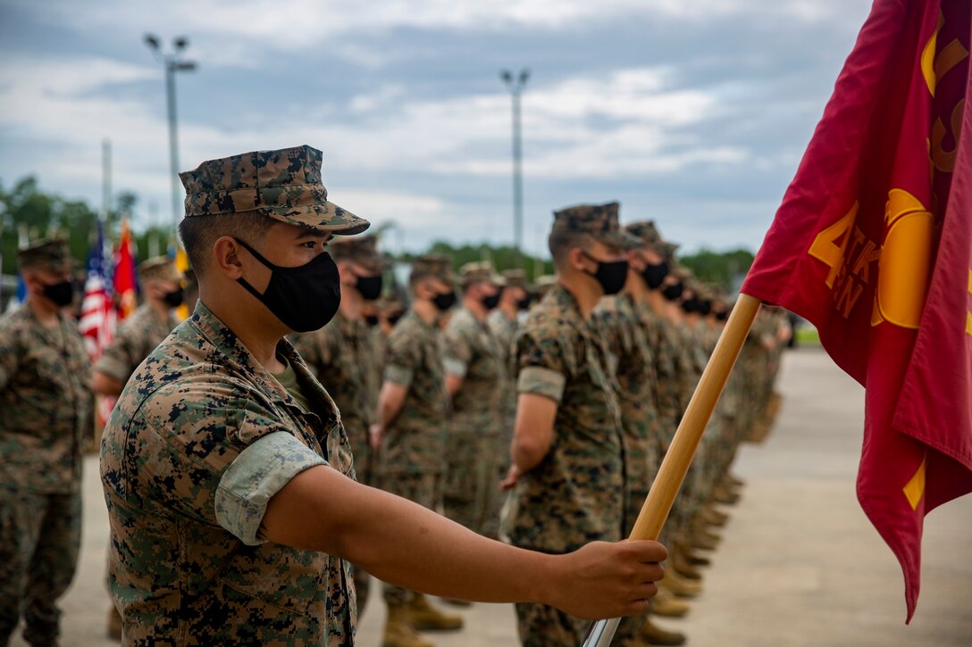 U.S. Marine Corps Sgt. Matthew Octaviano, a tank crewmember with Fox Company, 4th Tank Battalion, 4th Marine Division, holds the company guidon during a deactivation ceremony on Marine Corps Base Camp Lejeune at Stone Bay, North Carolina, Aug. 25, 2020. Gen. David H. Berger, the commandant of the Marine Corps, released Marine Corps Force Design 2030 in March 2020, which designates tanks as a large area of divestment. (U.S. Marine Corps photo by Lance Cpl. Christian Ayers)