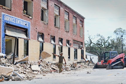 Airmen from the 159th Civil Engineering’s Debris Clearance Package clear rubble from a road in downtown Lake Charles, Louisiana, Aug. 30, 2020. The Louisiana Air National Guard Airmen arrived with heavy equipment after Hurricane Laura’s landfall to clear roadways of the hardest-hit areas in and round Calcasieu Parish.