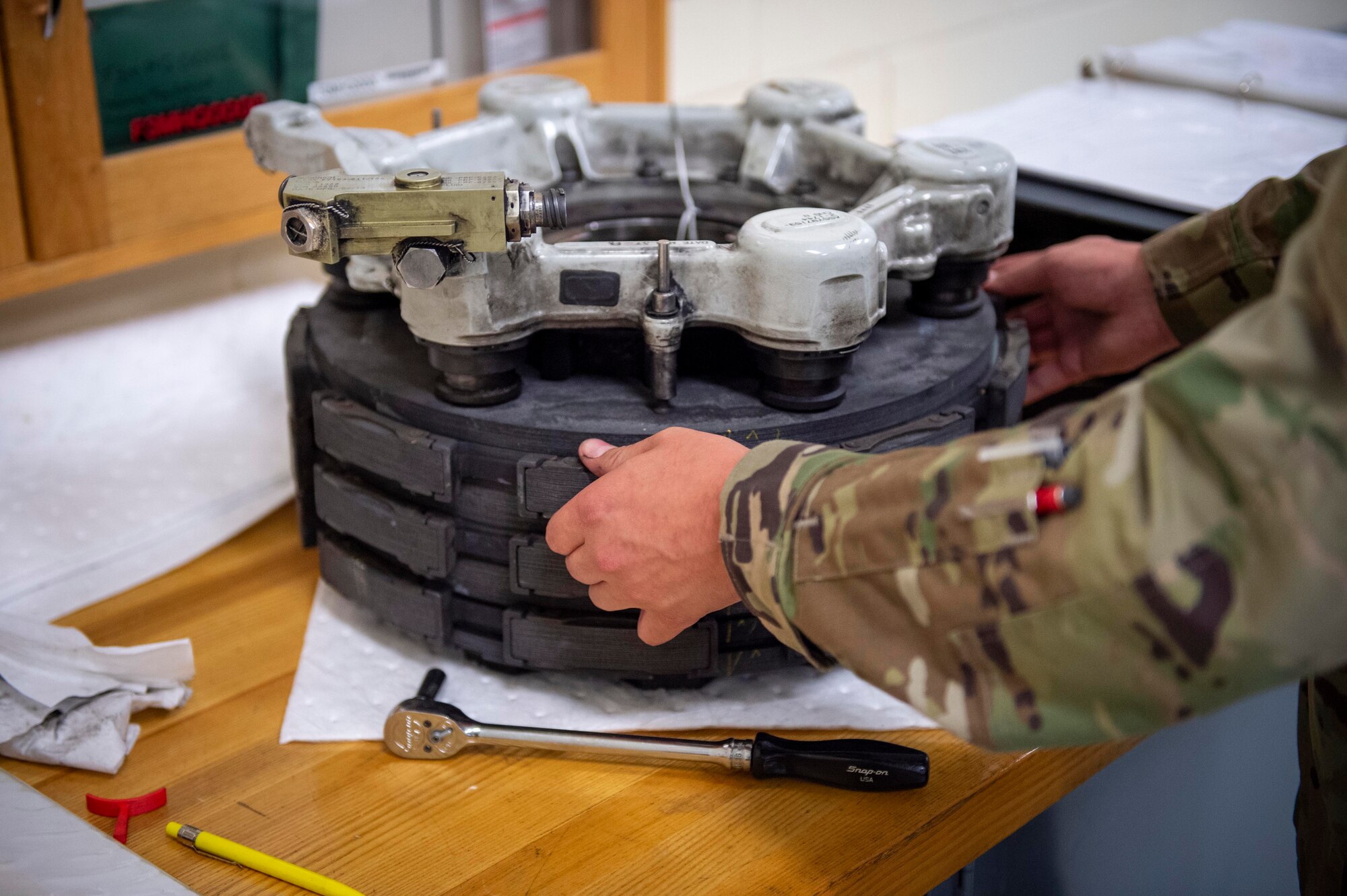 U.S. Air Force Airman 1st Class Maya Kaeding, hydraulic specialist, 133rd Maintenance Squadron, disassembles a brake assembly for refurbishment in St. Paul, Minn., Aug. 21, 2020.