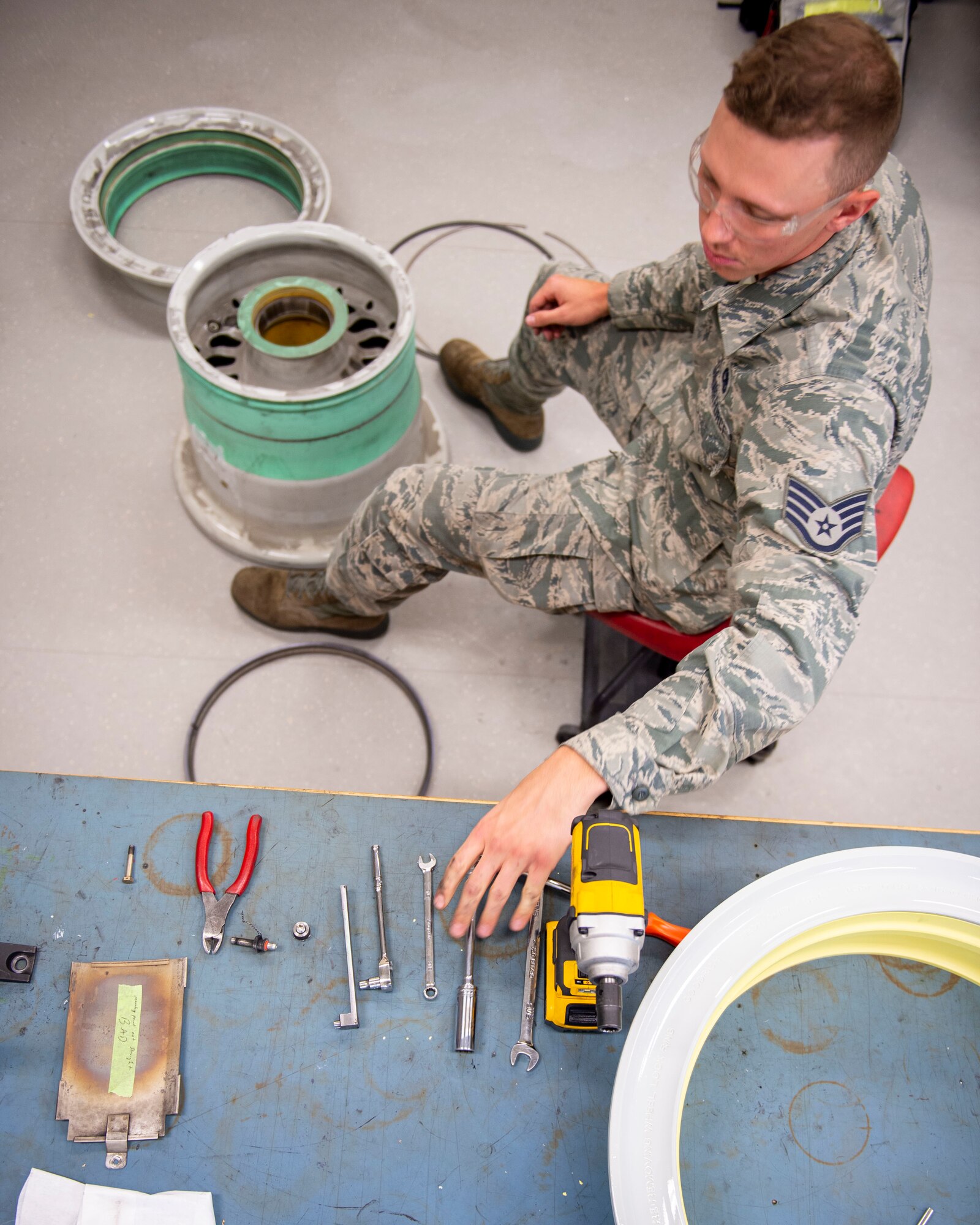 U.S. Air Force Staff Sgt. Logan Konigson, repair and reclamation specialist, 133rd Maintenance Squadron, disassembles a wheel assembly for refurbishment in St. Paul, Minn., Aug. 21, 2020.