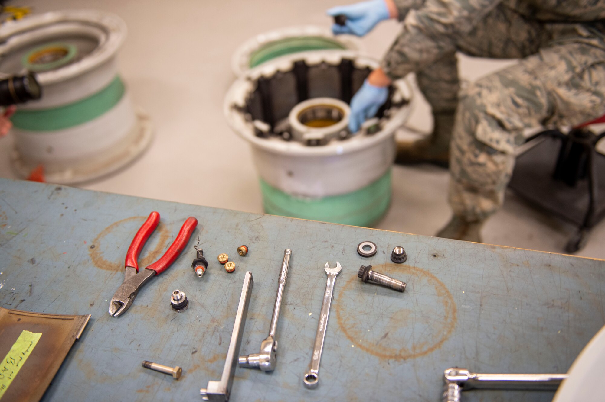 U.S. Air Force Staff Sgt. Logan Konigson, repair and reclamation specialist, 133rd Maintenance Squadron, disassembles a wheel assembly for refurbishment in St. Paul, Minn., Aug. 21, 2020.