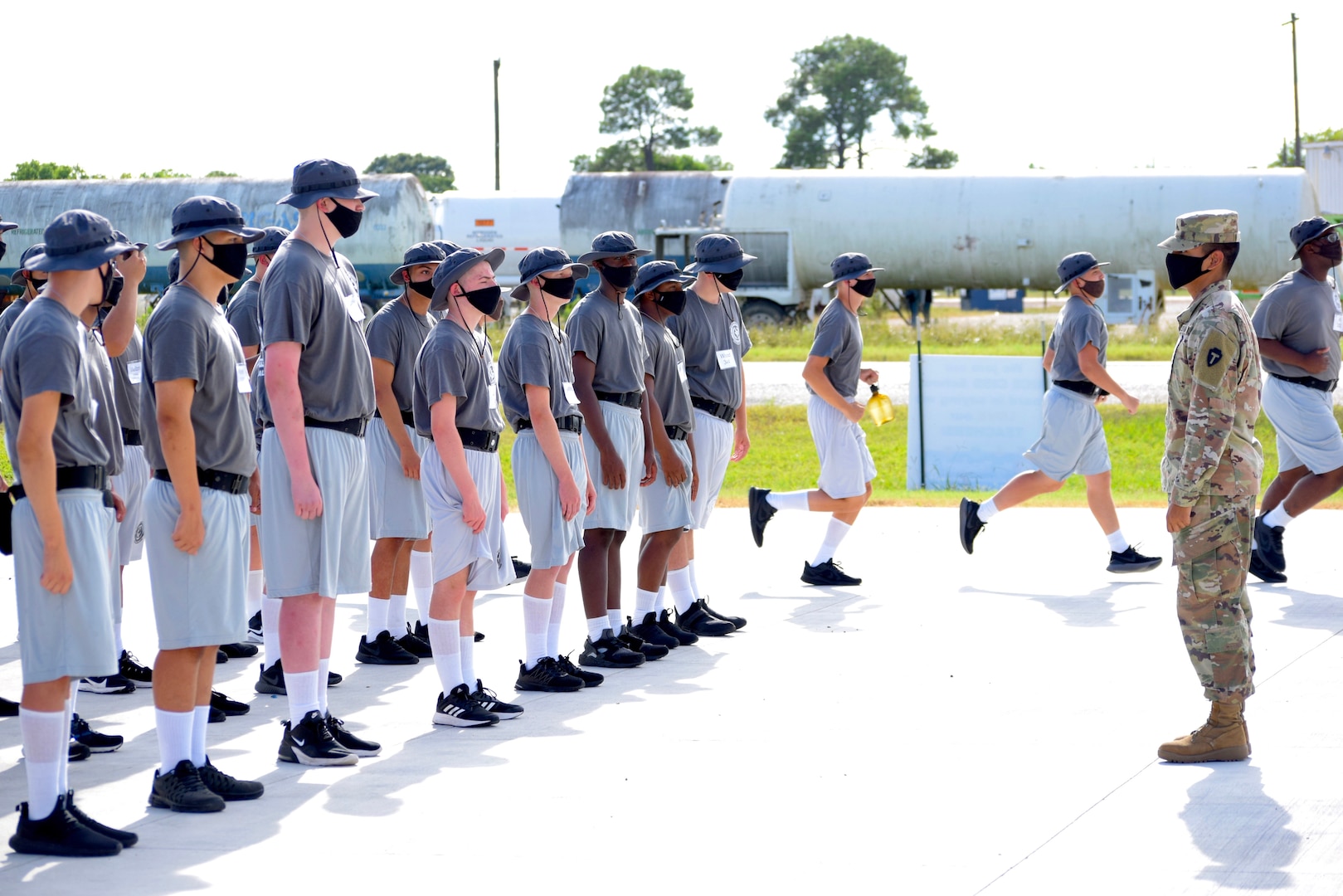 Pfc. Luis Lopez of the Texas National Guard Joint Counterdrug Task Force instructs cadets on drill and ceremony at the Texas ChalleNGe Academy in Eagle Lake, Texas. Service members, staff and students took precautions and measures to prevent the spread of COVID-19 while giving at-risk young people opportunities not afforded to them previously.