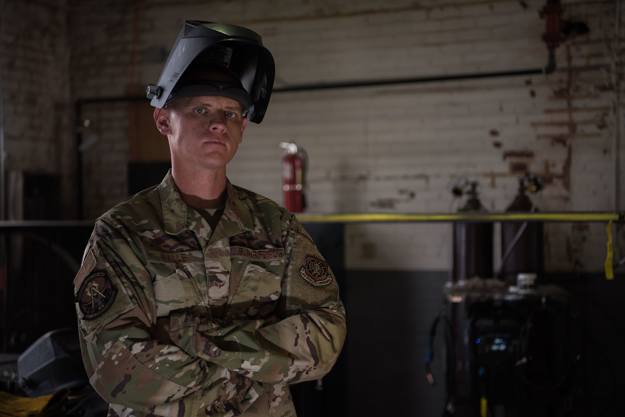 Airman 1st Class Colton Walls, 22nd Civil Engineer Squadron electrical power production technician, poses for a photo at the innovation lab Sep. 1, 2020, at McConnell Air Force Base, Kansas. Walls submitted his idea for a rake-like invention through AFWERX, a program with the goal of fostering a culture of innovation within the Air Force. Walls’ invention is a metal rake-like object that allows Airmen to reach in, dislodge and remove jammed concrete and debris from asphalt recyclers while allowing Airmen to remain a safe distance away. (U.S. Air Force photo by Airman 1st Class Marc A. Garcia)