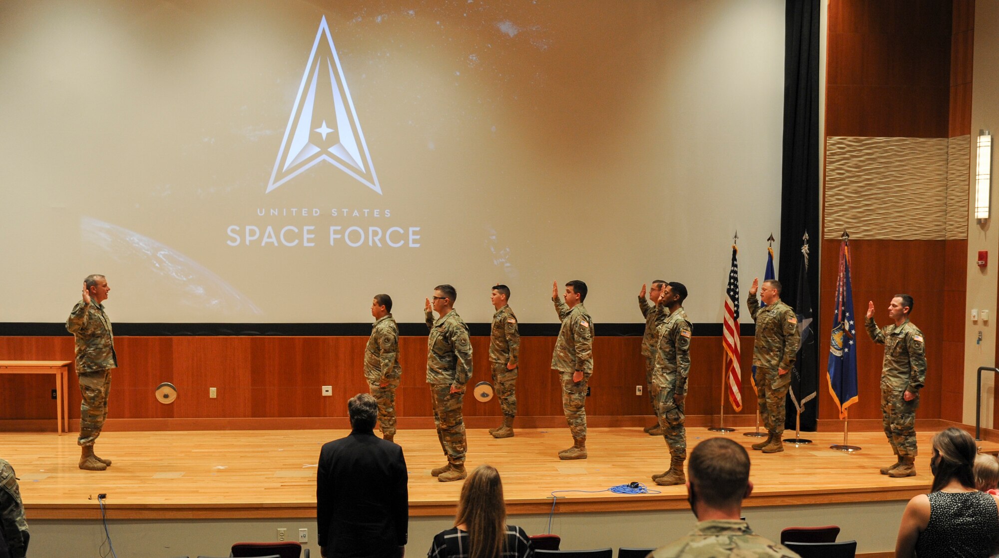 Eight of NASIC’s space operators recite the oath of enlistment during a transfer ceremony here Sept. 1. Administered by NASIC commander Col. Maurizio Calabrese, the oath is a military tradition that provides an opportunity for the members to reaffirm their commitment to the armed services. (U.S. Air Force photo by Senior Airmen Samuel Earick)