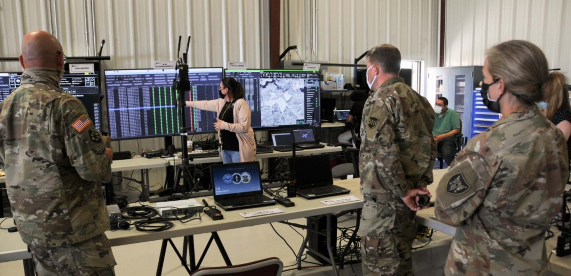 Photo of individuals watching a presentation.