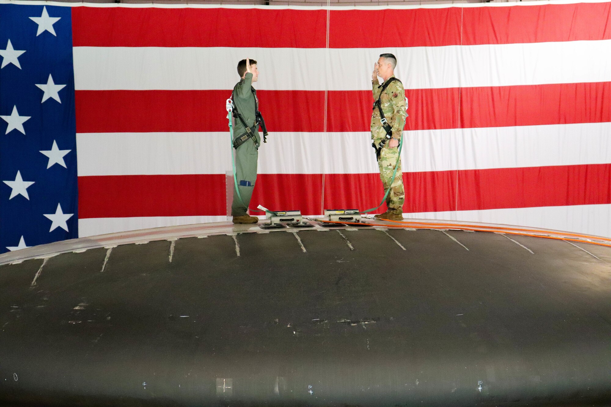 Airmen and family gathered in Dock Two on Sept. 1 to witness the final reenlistment for the highest ranking enlisted member in the 552nd Air Control Wing, Command Chief Master Sgt. Raymond “Kenny” Mott. The reenlistment ceremony occurred in a unique location due to the 15-month Isochronal Inspection: on top of the roto-dome of an E-3 Airborne Warning and Control System (U.S. Air Force photo by 1st Lt. Ashlyn K. Paulson).