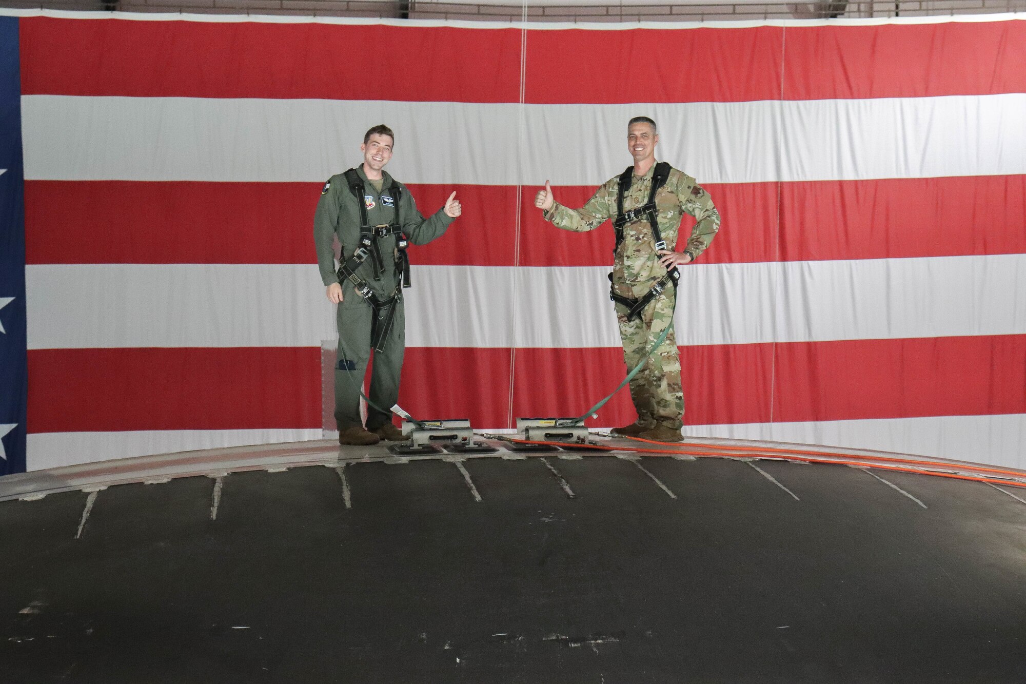 Airmen and family gathered in Dock Two on Sept. 1 to witness the final reenlistment for the highest ranking enlisted member in the 552nd Air Control Wing, Command Chief Master Sgt. Raymond “Kenny” Mott. The reenlistment ceremony occurred in a unique location due to the 15-month Isochronal Inspection: on top of the roto-dome of an E-3 Airborne Warning and Control System (U.S. Air Force photo by 1st Lt. Ashlyn K. Paulson).