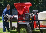 Senior Airman Henry Louis Kincaid, a pest management journeyman assigned to the 628th Civil Engineer Squadron, adjusts a belt on a buffalo turbine while preparing to lay down an insect barrier treatment at Joint Base Charleston, S.C., Aug. 17, 2020. The treatment controls the population of insects capable of carrying diseases. This allows members of JB Charleston to continue the mission and maintaining readiness.