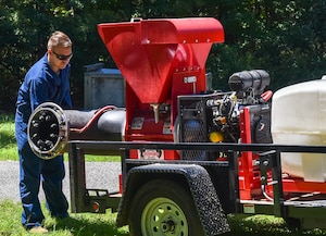 Senior Airman Henry Louis Kincaid, a pest management journeyman assigned to the 628th Civil Engineer Squadron, adjusts a belt on a buffalo turbine while preparing to lay down an insect barrier treatment at Joint Base Charleston, S.C., Aug. 17, 2020. The treatment controls the population of insects capable of carrying diseases. This allows members of JB Charleston to continue the mission and maintaining readiness.