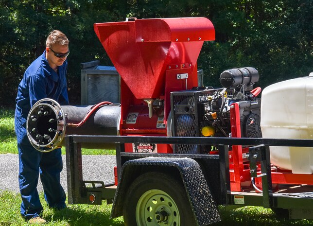 Senior Airman Henry Louis Kincaid, a pest management journeyman assigned to the 628th Civil Engineer Squadron, adjusts a belt on a buffalo turbine while preparing to lay down an insect barrier treatment at Joint Base Charleston, S.C., Aug. 17, 2020. The treatment controls the population of insects capable of carrying diseases. This allows members of JB Charleston to continue the mission and maintaining readiness.