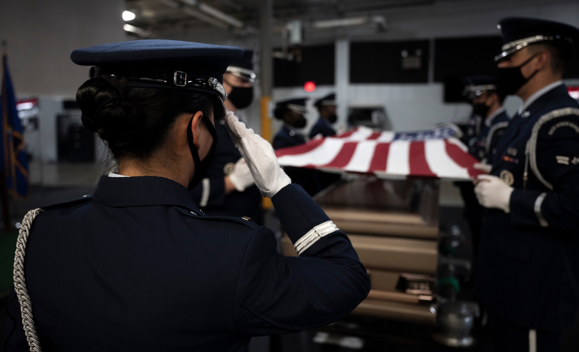 An Airman salutes the American flag