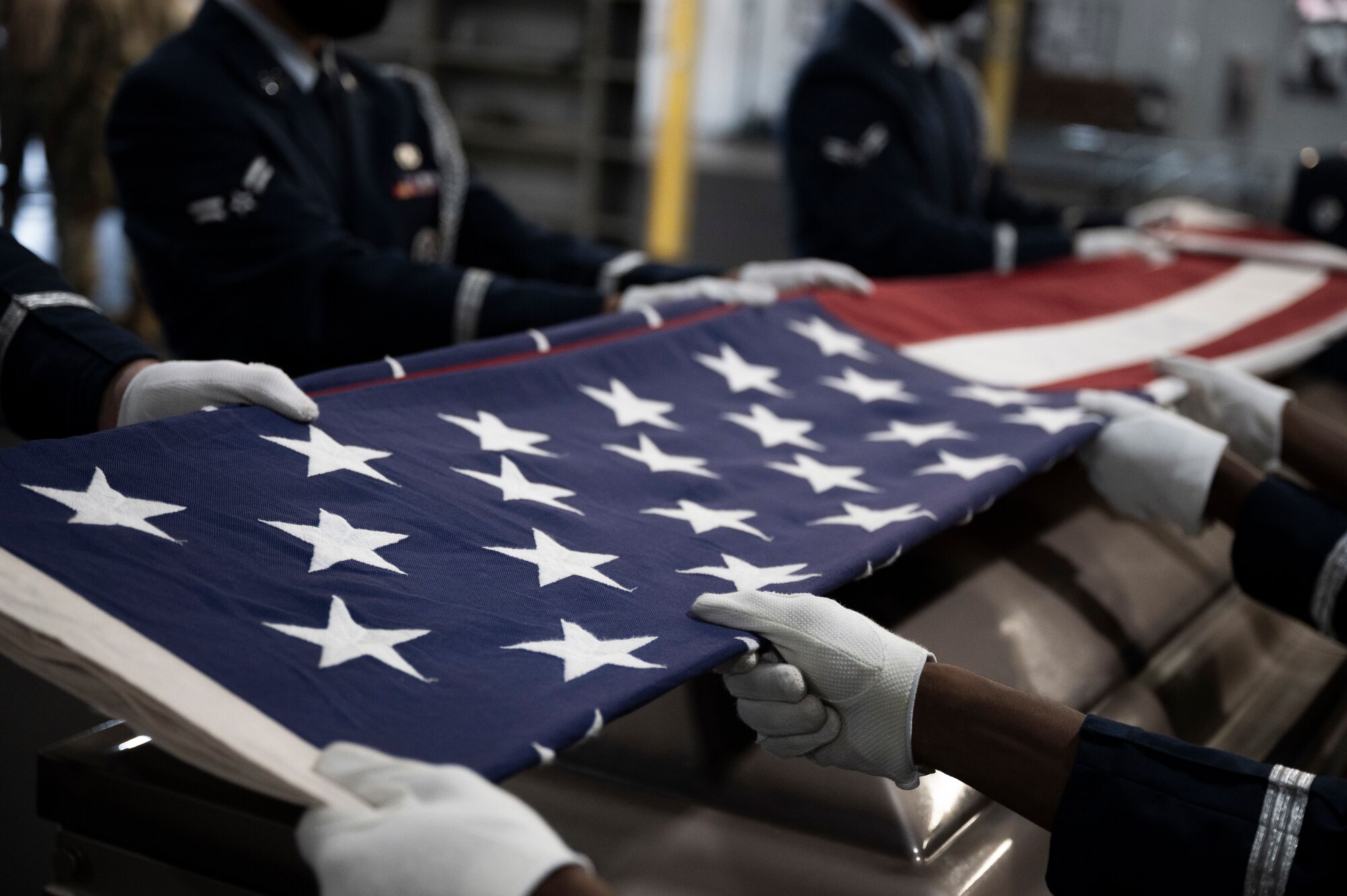 Airmen fold the American flag