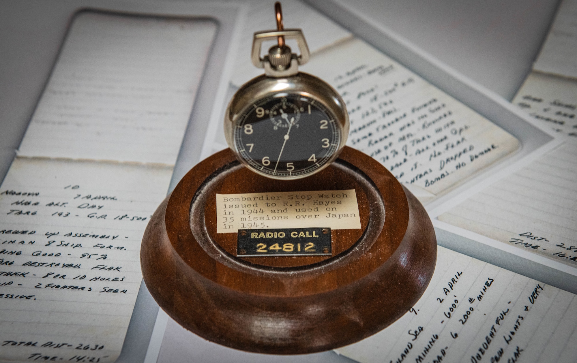 A bombardier stopwatch sits on photo copies of diary entries Aug. 12, 2020, in Sun City, Ariz.