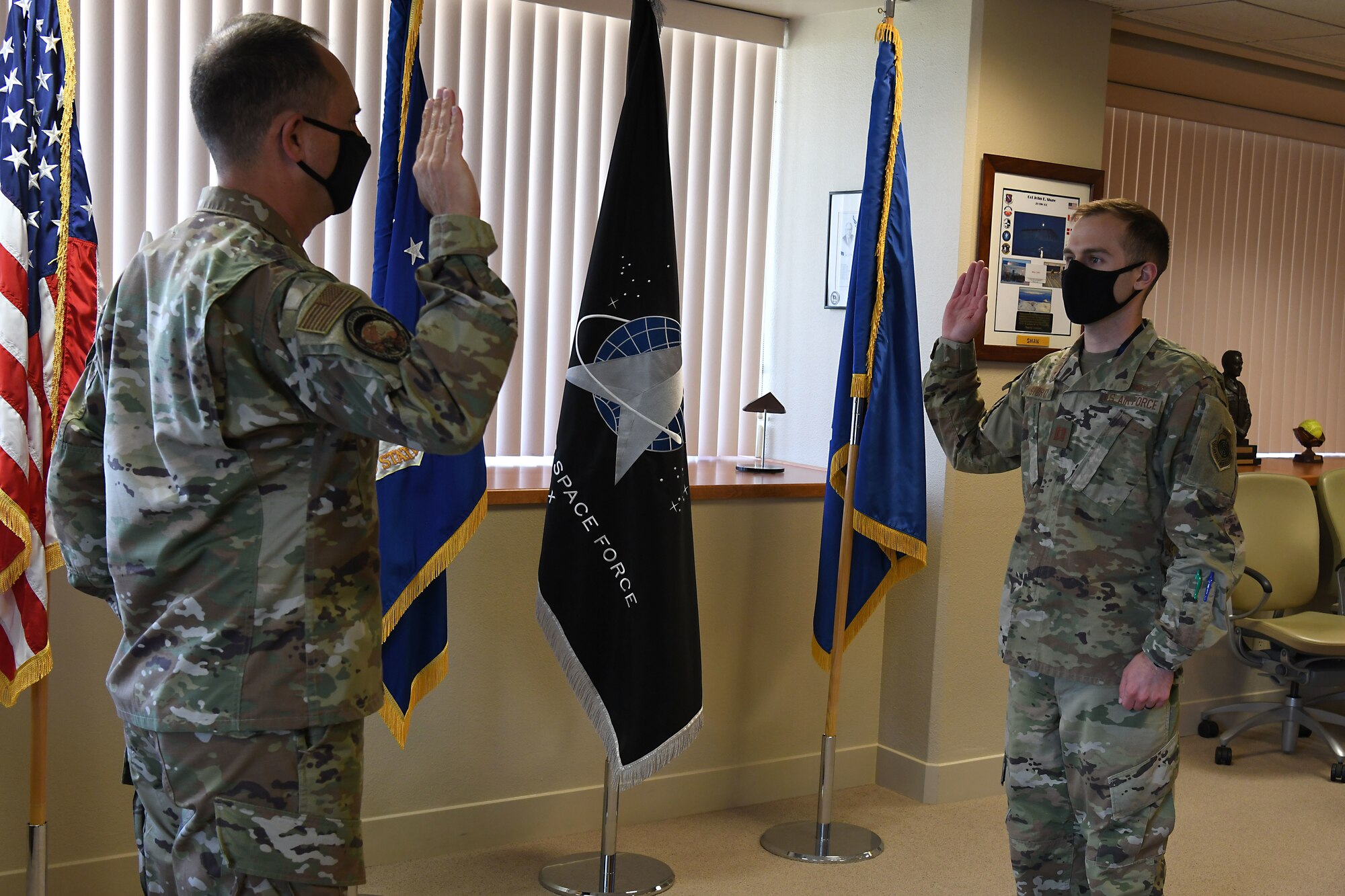 Maj. Gen. John E. Shaw, U.S. Space Force’s Space Operations Command commander, gives the commissioning oath to Capt. Thomas Stortz, SpOC aide-de-camp, into the United States Space Force, Sept. 1, 2020, at Vandenberg AFB, Calif.