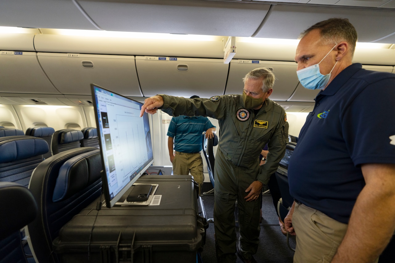 Two people going over a coronavirus airflow particle test.