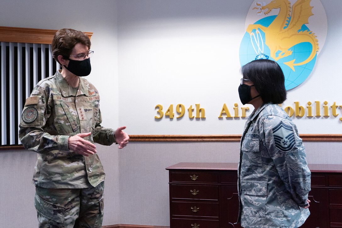 U.S. Air Force Gen. Jacqueline D. Van Ovost, Air Mobility Command commander, recognizes Senior Master Sgt. Louann Cornel, 749th Aircraft Maintenance Squadron superintendent, during Van Ovost’s visit to the 349th Air Mobility Wing Headquarters, Travis Air Force Base, California, Sept. 1, 2020.