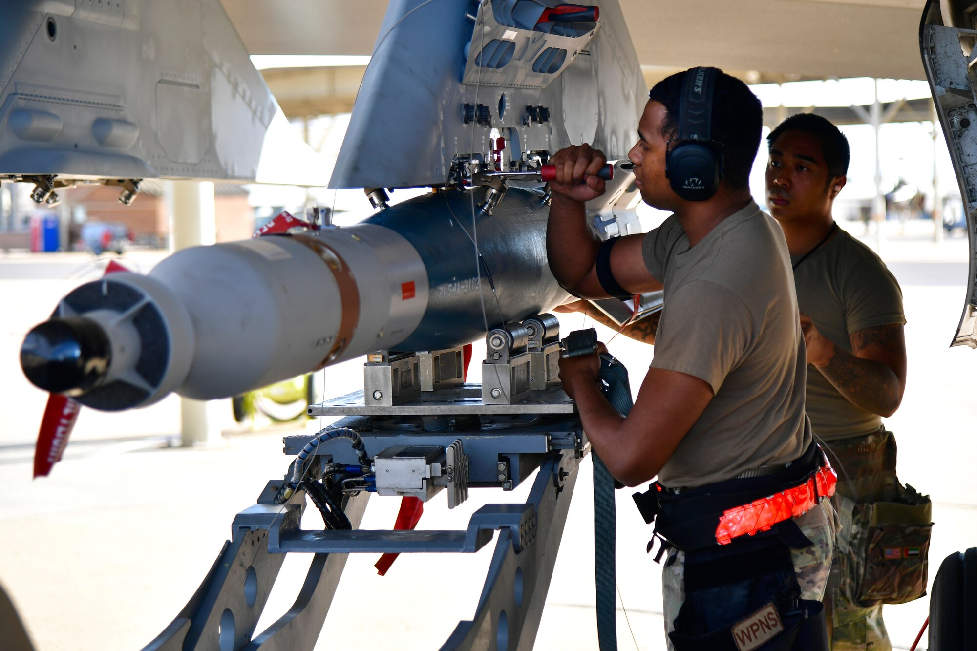 a photo of a weapons load crew