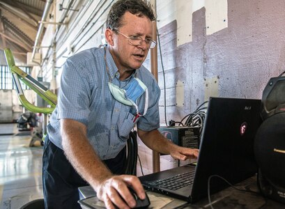 Jon Cutshall, Southwest Research Institute engineer, downloads stress test data from a T-38 after using a remotely controlled aircraft towing system August 27, 2020 at Joint Base San Antonio-Randolph. The RCATS will reduce manpower requirements, allow close quarter towing and quicker aircraft stowing ahead of inclement weather.