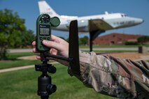 Hand adjusting a handheld weather data tool
