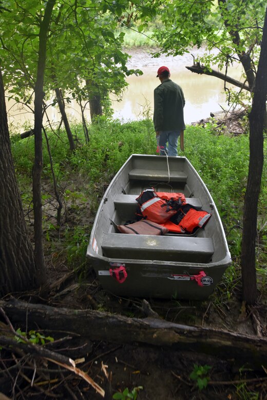 Man pulls boat toward river